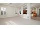 Bright living room featuring large windows and an open view to the kitchen area at 9435 E Mohawk Ln, Scottsdale, AZ 85255