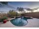 Inviting pool with waterfall feature surrounded by desert landscaping at 9435 E Mohawk Ln, Scottsdale, AZ 85255