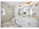 Bright bathroom with double sinks, granite countertop, and walk-in shower at 9675 E Cinnabar Ave, Scottsdale, AZ 85258