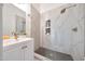 Stylish bathroom featuring a walk-in shower with sleek tiling, a sink and vanity at 9675 E Cinnabar Ave, Scottsdale, AZ 85258