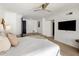 Bright bedroom featuring a large bed, TV, and neutral decor and adjacent sitting room with black door at 9675 E Cinnabar Ave, Scottsdale, AZ 85258