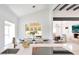 Elegant dining area with modern chandelier and view of the living room beyond at 9675 E Cinnabar Ave, Scottsdale, AZ 85258