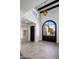 Entryway showcasing high ceilings, arched window and a glimpse of the home's modern design at 9675 E Cinnabar Ave, Scottsdale, AZ 85258