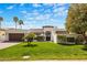 A luxurious home features a well-manicured lawn, desert landscaping, and a circular driveway at 9675 E Cinnabar Ave, Scottsdale, AZ 85258