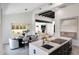 Open concept room with kitchen island, dining, and view of the living room at 9675 E Cinnabar Ave, Scottsdale, AZ 85258
