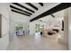 Open-concept living space with kitchen, dining, and living areas under beamed ceilings at 9675 E Cinnabar Ave, Scottsdale, AZ 85258