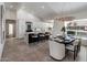 Eat-in kitchen and dining area with black island and white countertops plus modern designer light fixture at 9675 E Cinnabar Ave, Scottsdale, AZ 85258