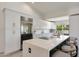 Bright kitchen featuring white cabinetry, stainless appliances, and a large center island at 9675 E Cinnabar Ave, Scottsdale, AZ 85258