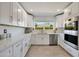 Contemporary kitchen with white cabinets, quartz countertops, and stainless steel appliances at 9675 E Cinnabar Ave, Scottsdale, AZ 85258