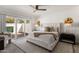 Serene main bedroom with sliding doors to the patio, a neutral color palette, and designer furnishings at 9675 E Cinnabar Ave, Scottsdale, AZ 85258