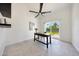 Home office with a ceiling fan and sliding door to the backyard at 9675 E Cinnabar Ave, Scottsdale, AZ 85258