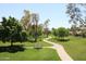 Scenic view of a lush green park with walking paths, mature trees, and manicured lawns at 9675 E Cinnabar Ave, Scottsdale, AZ 85258