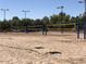 Outdoor volleyball courts with nets and lighting in a community park or sports complex at 9675 E Cinnabar Ave, Scottsdale, AZ 85258