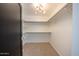 Bright and spacious walk-in closet with shelves and hanging rods at 9675 E Cinnabar Ave, Scottsdale, AZ 85258