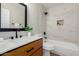 Modern bathroom with a wooden vanity, stylish fixtures, and a tiled shower-over-tub at 9705 E Mountain View Rd # 1056, Scottsdale, AZ 85258