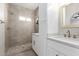 Elegant bathroom featuring double sinks, stone shower with glass door, and modern fixtures for a spa-like experience at 9705 E Mountain View Rd # 1056, Scottsdale, AZ 85258