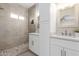 Modern bathroom featuring double sinks, stone shower with glass, and elegant fixtures, providing a spa-like experience at 9705 E Mountain View Rd # 1056, Scottsdale, AZ 85258