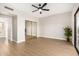 Inviting bedroom with wood floors, ceiling fan, and mirrored closet doors, offering a serene and stylish retreat at 9705 E Mountain View Rd # 1056, Scottsdale, AZ 85258