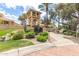 Welcoming entrance to the Racquet Club, featuring lush landscaping and a charming tower at 9705 E Mountain View Rd # 1056, Scottsdale, AZ 85258