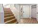 Bright entryway showcases wood-look stairs and floors with white front door and ample natural light, creating a welcoming ambiance at 9705 E Mountain View Rd # 1056, Scottsdale, AZ 85258