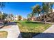 Open green space surrounded by apartments on a beautiful, sunny day at 9705 E Mountain View Rd # 1056, Scottsdale, AZ 85258