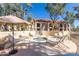 A community hot tub area with lounge chairs and tables surrounded by trees and shade at 9705 E Mountain View Rd # 1056, Scottsdale, AZ 85258