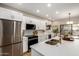 Bright kitchen featuring stainless steel appliances, white cabinets, and a center island with bar seating at 9705 E Mountain View Rd # 1056, Scottsdale, AZ 85258