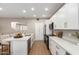 Modern kitchen showcasing stainless appliances, white cabinets, and an island with bar seating at 9705 E Mountain View Rd # 1056, Scottsdale, AZ 85258