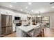 Bright kitchen featuring stainless steel appliances, white cabinets, and a center island with bar seating at 9705 E Mountain View Rd # 1056, Scottsdale, AZ 85258