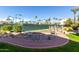 Tennis courts surrounded by a pond, rocks, a small bridge, and a walking path at 9705 E Mountain View Rd # 1056, Scottsdale, AZ 85258