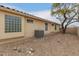 Backyard view showing tan home exterior and gravel landscaping at 10012 W Runion Dr, Peoria, AZ 85382