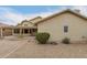 Exterior of home showing the backyard, featuring desert landscaping and a covered patio at 10012 W Runion Dr, Peoria, AZ 85382