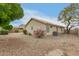 Exterior of home showing the desert landscaping and backyard with mature trees at 10012 W Runion Dr, Peoria, AZ 85382