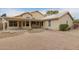 Backyard featuring a covered patio and low-maintenance desert landscaping at 10012 W Runion Dr, Peoria, AZ 85382