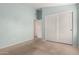 Bedroom with light blue walls, double closet and entry to another room at 10012 W Runion Dr, Peoria, AZ 85382