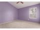 Bedroom with lilac walls with carpet and a window to let in natural light at 10012 W Runion Dr, Peoria, AZ 85382