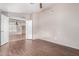 Open bedroom layout showcasing wood-look floors and a view into the living area at 10012 W Runion Dr, Peoria, AZ 85382
