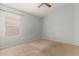 Comfortable bedroom featuring a window and carpeted floors at 10012 W Runion Dr, Peoria, AZ 85382