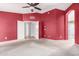Spacious bedroom with red walls and open doorway to the next room at 10012 W Runion Dr, Peoria, AZ 85382