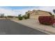 This home features a spacious driveway, a 2-car garage, and desert landscaping at 10012 W Runion Dr, Peoria, AZ 85382