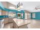 Bright kitchen with island, blue accent walls, lots of natural light and views of the backyard at 10012 W Runion Dr, Peoria, AZ 85382