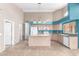 Spacious kitchen with an island, white appliances and adjacent area. Neutral wall and accent blue at 10012 W Runion Dr, Peoria, AZ 85382