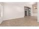 Open-concept living room with tile floors, neutral paint, and a glimpse into other rooms at 10012 W Runion Dr, Peoria, AZ 85382