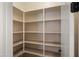 Walk-in pantry with built-in shelving, offering ample storage space for kitchen essentials at 10334 E Radiant Ave, Mesa, AZ 85212