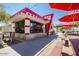 Charming exterior view of a quaint restaurant with outdoor seating and vibrant red and white decor at 10334 E Radiant Ave, Mesa, AZ 85212