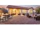A large backyard with an outdoor kitchen, covered patio, seating areas, and a fire pit at 1197 W Rolls Rd, San Tan Valley, AZ 85143