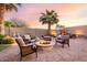 Spacious backyard with a fire pit and seating, creating a perfect outdoor retreat at 1197 W Rolls Rd, San Tan Valley, AZ 85143