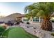 Serene backyard with putting green, desert landscaping, and mountain views, offering relaxation and recreation at 1197 W Rolls Rd, San Tan Valley, AZ 85143