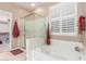 Bathroom boasts a soaking tub, glass shower, and window shutters at 1197 W Rolls Rd, San Tan Valley, AZ 85143