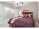 Comfortable bedroom features neutral walls, ceiling fan, and access to a private balcony at 1197 W Rolls Rd, San Tan Valley, AZ 85143